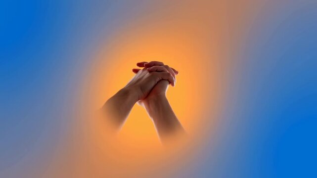 hands praying in a peaceful and spiritual abstract background with gradient colors. neutral perspective, religion, spirituality, blue, orange, commercial, natural, light, clean, copy space.