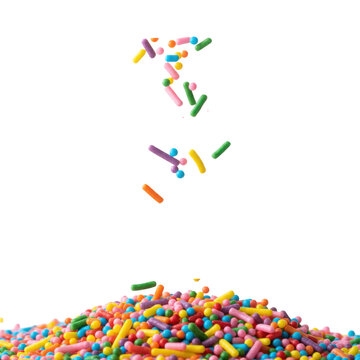 Thousands of vibrant candy sprinkles and jimmies falling onto a white background to create a colorful pile with extreme detail playful and energetic atmosphere