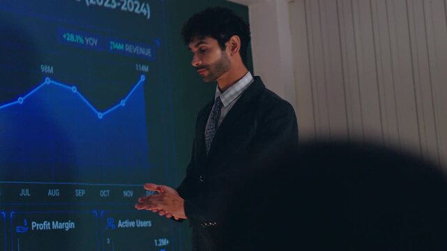 Businessman presentation chart graph meeting office finance professional suit data analytics dashboard speaker audience strategy report revenue profit margin growth trend line screen