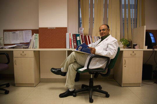 Doctor sitting with a magazine 