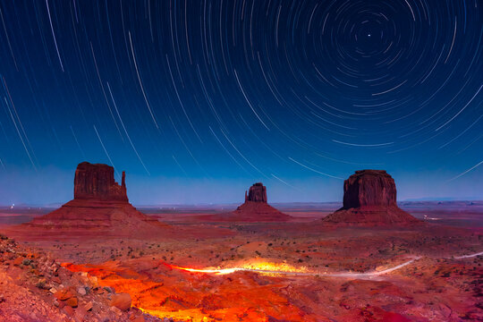 Monument Valley Butte Silhouette at Sunrise with Desert Mist and Vibrant Dawn Sky, Arizona, Utah, USA