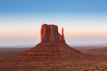 Monument Valley Butte Silhouette at Sunrise with Desert Mist and Vibrant Dawn Sky, Arizona, Utah, USA © somchaij