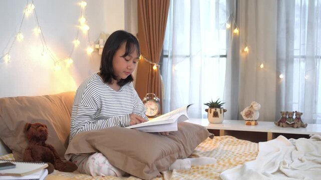 Young woman sitting comfortably on bed, Peaceful Evening Reading in a Cozy Bedroom with soft fairy lights	
