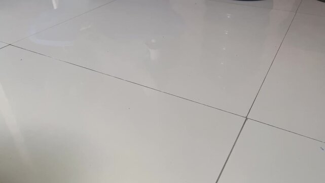 Clean shiny white ceramic tile floor background