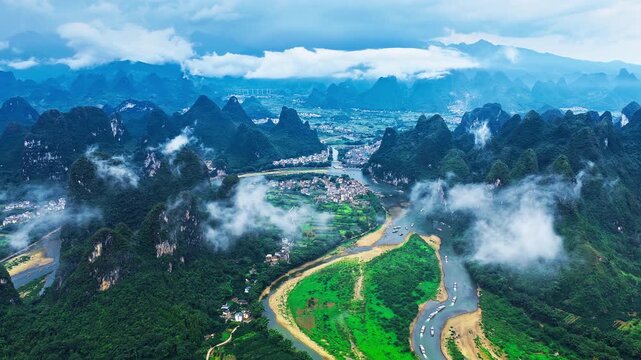 Panoramic aerial view of Guilin karst mountain landscape with Li River, fog, and lush green countryside in Guangxi, China. Ideal for travel and tourism concept.