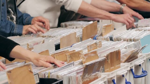 Music Shoppers Explore Vinyl Albums in Record Store Display Bins