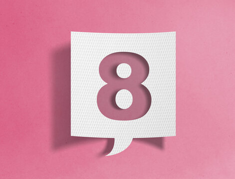 Paper speech bubble with number eight cutout on pink background, ranking and sequence concept