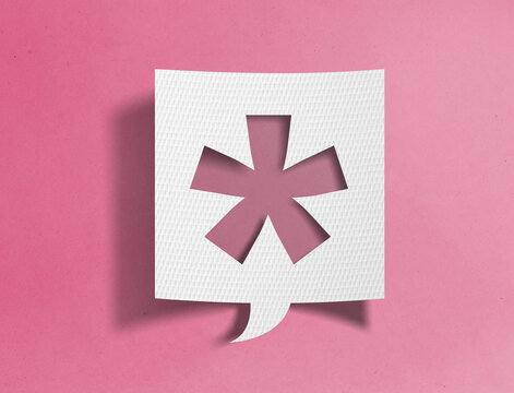 Paper speech bubble with asterisk cutout on pink background, typography and communication concept