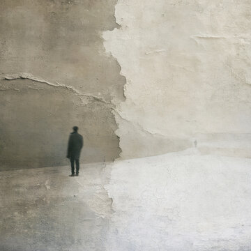 Wallpaper background of abstract textured wall with blurred lone man silhouette in misty beige landscape