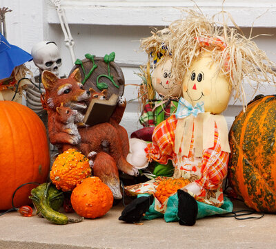 A traditional autumn display of pumpkins, a couple of hay dolls, a fox with cubs and a skeleton in Stockbridge, Massachusetts