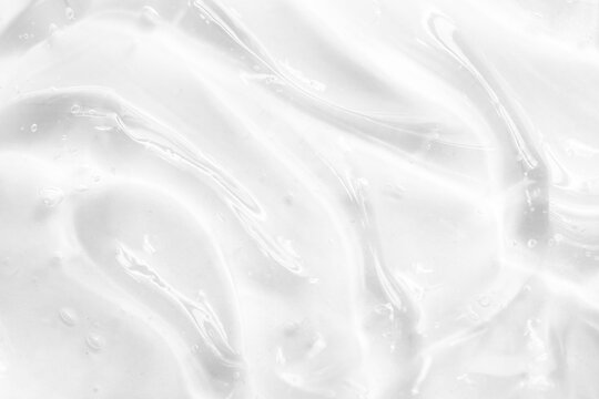 Cosmetic gel, serum transparent sample. Liquid cream with bubble texture. Gel texture of a cosmetic product. Clear liquid lotion for skin care.