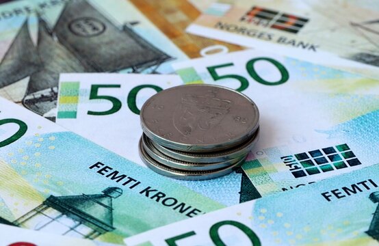 Norwegian krone money banknotes and coins on table. Norway cash bills of NOK currency