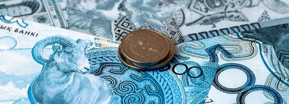 Kazakhstani tenge money banknotes and coins on table. Kazakhstan cash bills of KZT currency