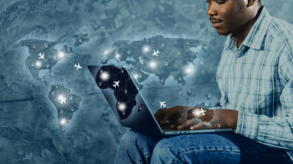 Travel booking process using a laptop with a world map background showing flight routes and locations © fotofabrika