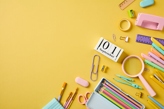 September 1 calendar and school supplies frame on yellow background