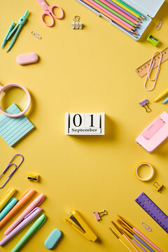 Vertical September 1 calendar with school supplies frame on yellow