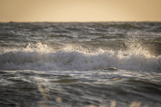 Surf, breaking wave against light, Sorteb&aelig;rdalen Strand, Houvig, North Sea, Denmark
