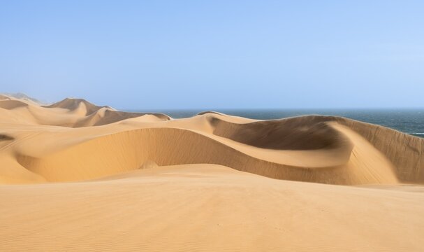 Sand dunes and sea, dune sea, impressive desert landscape, Sandwich Harbour, Namib Naukluft Park, Namibia
