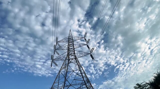 Close up bottom view electricity overhead power lines on blue sky in islamabad, Pakistan. High voltage transmission network lines, Double Circuit Steel pole transmission tower, transmission lines.