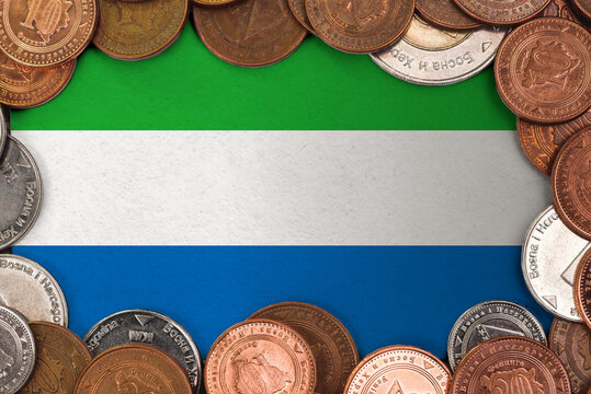 Coins on flag of Sierra Leone trading investment business currency concept
