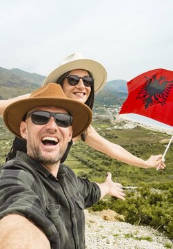 Happy young pretty woman handsome woman tourist enjoying summer holiday in Sarande, Albania - Traveling life style concept taking selfie in Balkans - Tourism and summertime vacation concept