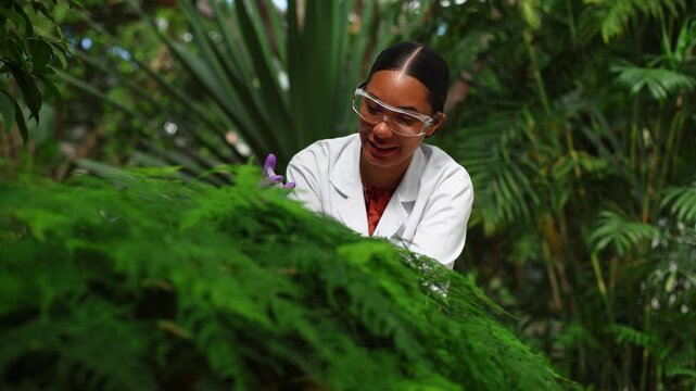 Female botanist injecting liquid into a plant for research