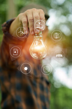 Man Holding Light Bulb with Clean Energy Icons, Illustrating Sustainable Ideas