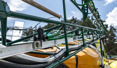 Agricultural field sprayer nozzle body on boom for pesticide application. Modern crop protection machinery engineering component and farming transport equipment closeup details for cultivation. © NastyaPhoto