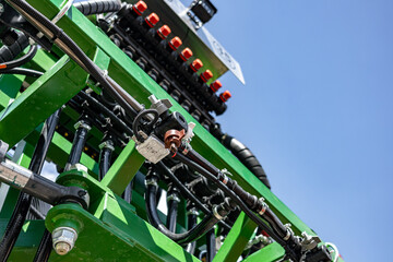 Agricultural field sprayer nozzle body on boom for pesticide application. Modern crop protection machinery engineering component and farming transport equipment closeup details for cultivation. © NastyaPhoto