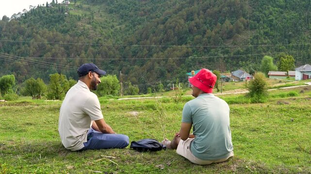 Friends resting in nature. Hikers relaxing at Jibhi village, Manali, Himachal Pradesh.