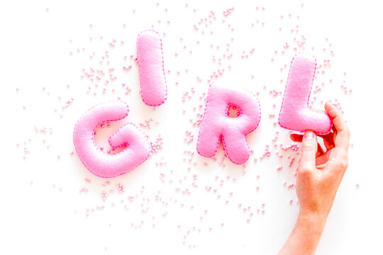Girl word as decoration for baby shower on white background top view