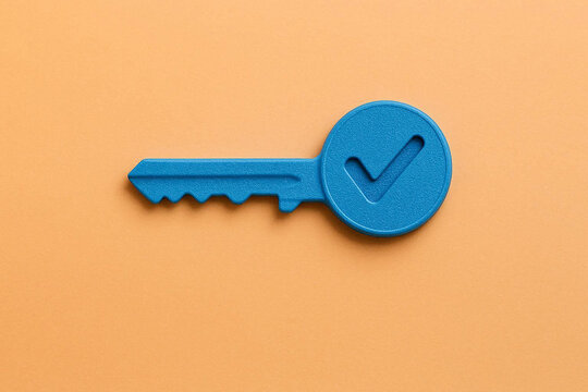 Modern Blue Key with Checkmark Icon on Orange Background