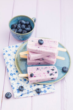 Homemade blueberry yogurt ice pops on a plate