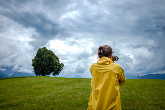 Germany, Bavaria, Teenage girl taking pictures at Wittelsbacher Hoehe