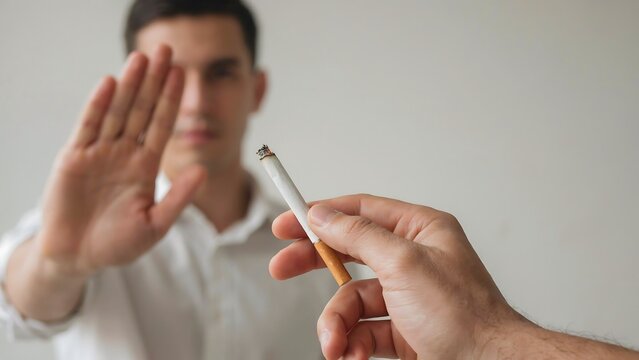 Man refusing cigarette with stop hand gesture promoting no smoking and healthy lifestyle