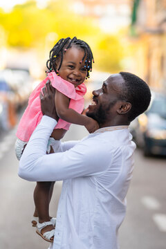 Cheerful father and daughter on road