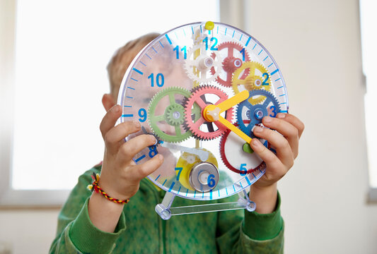 Boy playing with toy clock