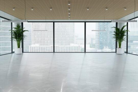 Empty modern office workspace with large window and city view