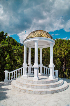 The rotunda is snow-white against a background of clouds on a clear sunny day. Travel landscape sights of Europe.