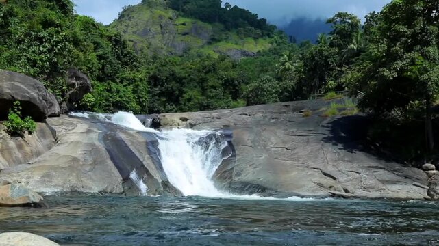 his waterfall flows through the Western Ghats over laterite rock, where the Kadalundi River descends into a forested valley. Adyanpara Falls, Malappuram, Kerala, India.