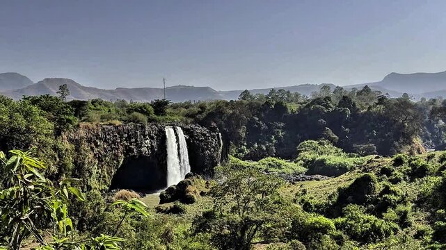 This waterfalls surge over basalt cliffs, where the Blue Nile River creates powerful cascades amid Ethiopia's scenic highlands. Blue Nile Falls, Amhara Region, Ethiopia.