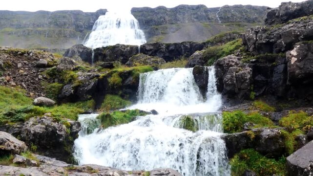 This waterfalls cascade down moss covered cliffs, where the Fossa River flows through a lush canyon in Iceland's southern highlands. Fjallfoss, Skaftafell, Iceland.