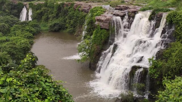 This waterfall flows over layered cliffs, where lush vegetation and the Chandravanka River enhance the scenic beauty. Ethipothala Falls, Palnadu District, Andhra Pradesh, India.