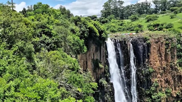 This waterfalls plunge into awhere the Umgeni River creates a spectacular cascade surrounded by green hills. Howick Falls, KwaZulu-Natal, South Africa.