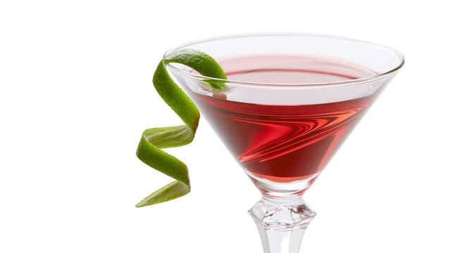 Red cocktail in martini glass with lime twist