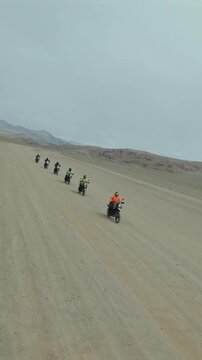 Vertical FPV Drone View of Adventure Motorcyclists Crossing Desert Plains in Ladakh