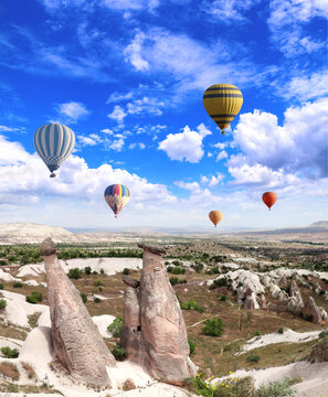 Balloon flight, famous tourist attraction of Cappadocia. Air balloons and Fairy Chimney in Pasabag Valley, Anatolia, Turkey. Topic of vacation, travel, trip abroad on vacation, cruises and tours