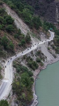 Vertical Aerial View of Bikers Riding Along Chamera Lake Road, Himachal Pradesh