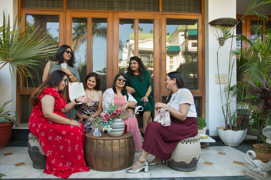 Women chatting together in the backyard during a get together. 