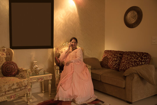 Woman sitting elegantly in her home. 